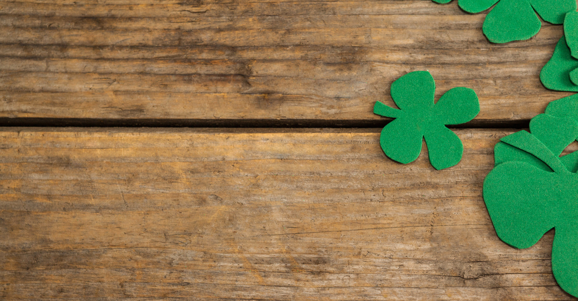 Dad pushing Daughter in Cardboard Box on Hardwood Floors