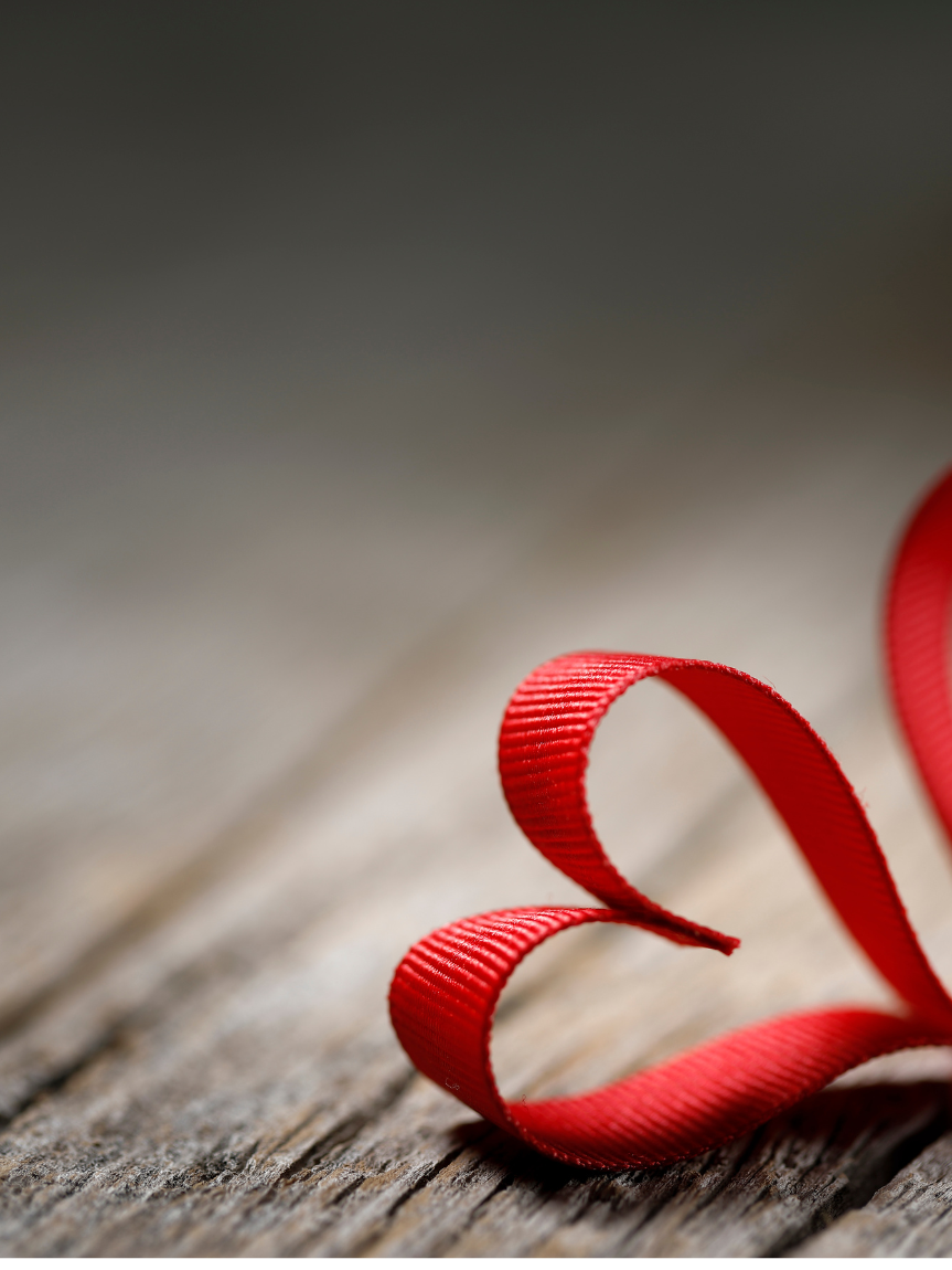 Dad pushing Daughter in Cardboard Box on Hardwood Floors